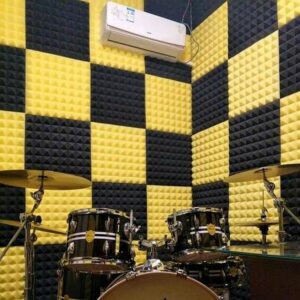noise dampening acoustic horn in yellow and black in a drum studio