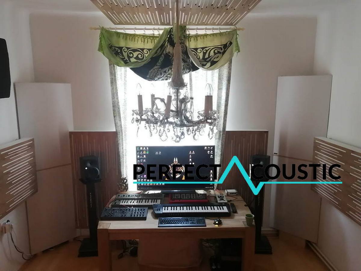 Mixing desk with studio wall panels and ceiling acoustic treatment