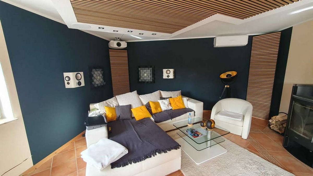 Wood acoustic ceiling panels combined with wall treatments in a living room